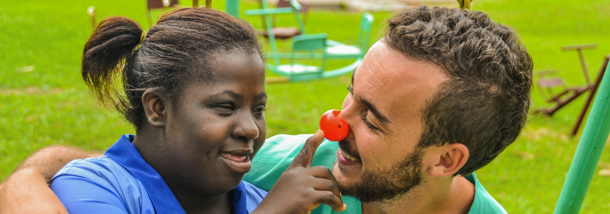 Girl and volunteer playing in Dompoase, Ghana
