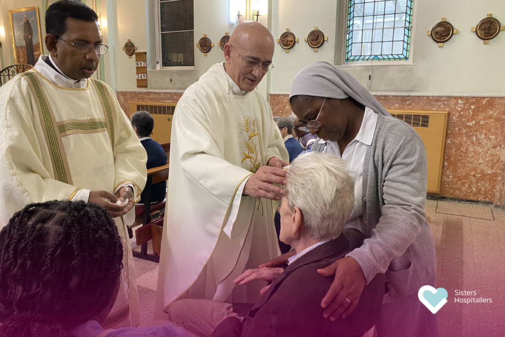 Priest blessing a patient with holy oil during World Day of the Sick London 2026.