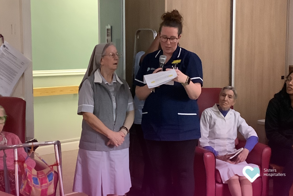 Staff member reading during World Day of the Sick at St Augustine’s Addlestone