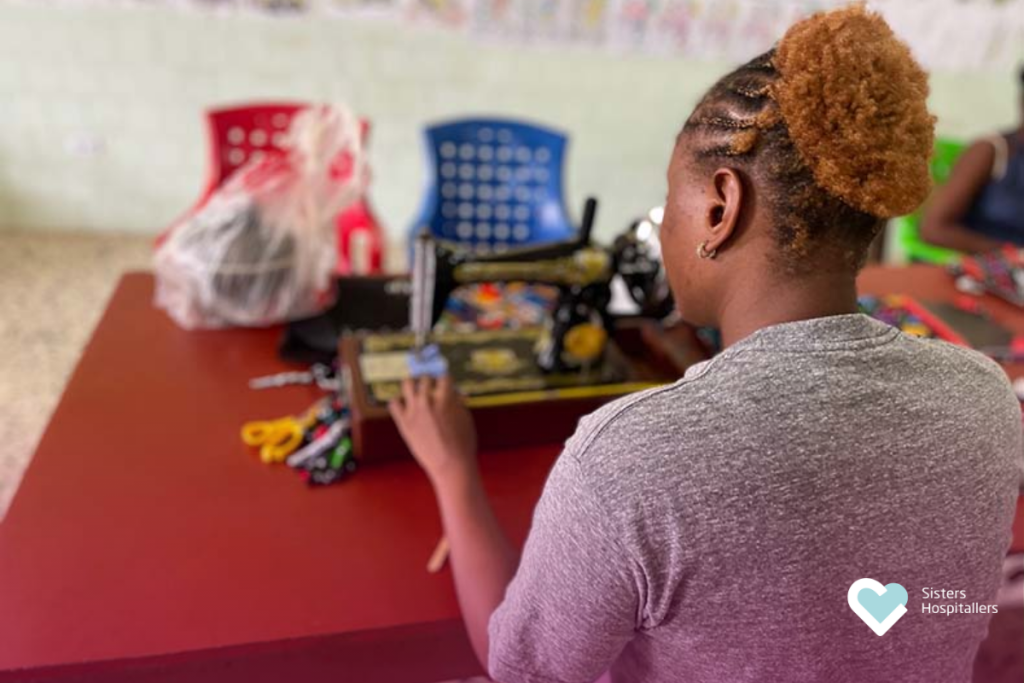Woman learning sewing skills as part of empowerment and support activities