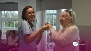 Carer and resident enjoying a dancing activity together at Footherley Hall care home in Shenstone