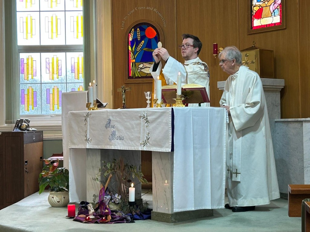Priest celebrating the Eucharist during Our Lady of the Annunciation Mass at Footherley Hall Shenstone 