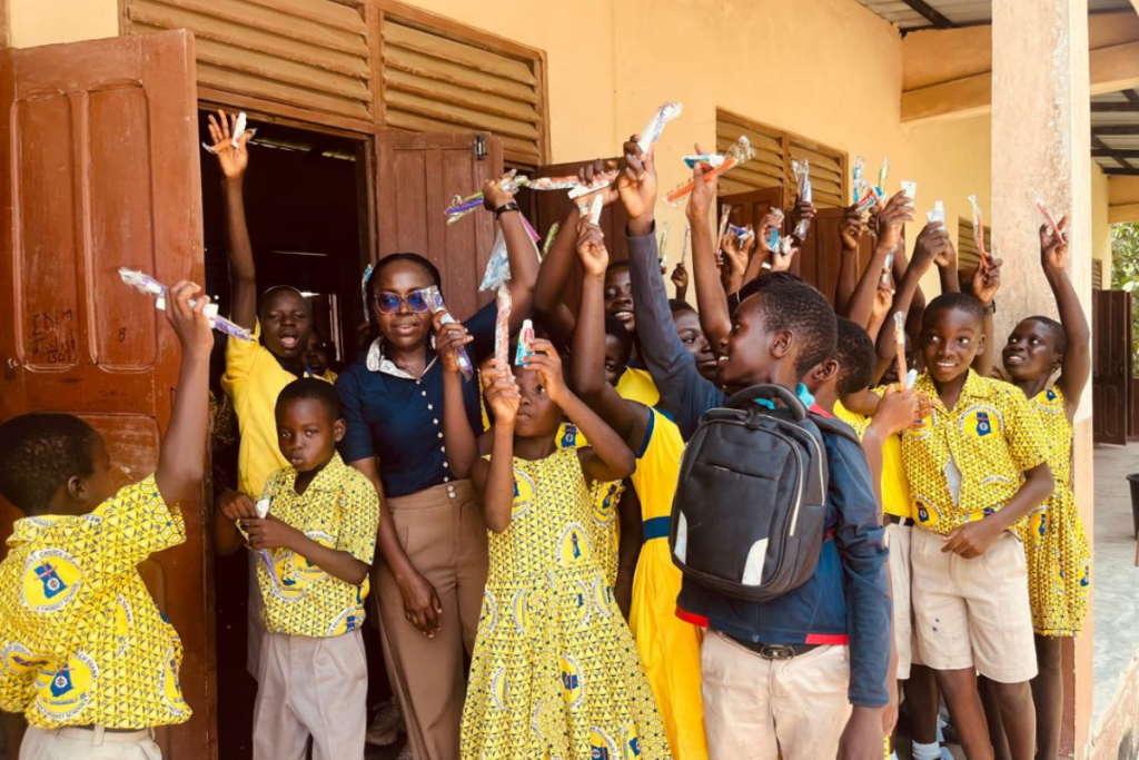 Students holding toothbrushes during oral health outreach at Foso Methodist B School Ghana