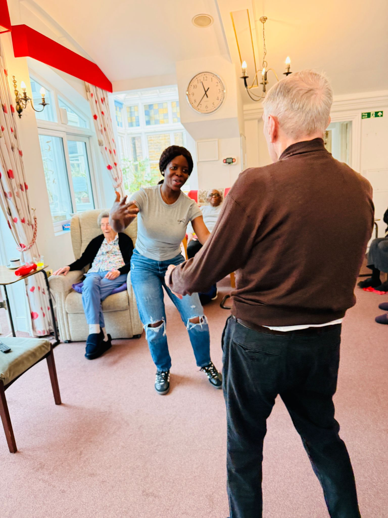 Resident and staff member dancing together during a movement session at St Teresa’s